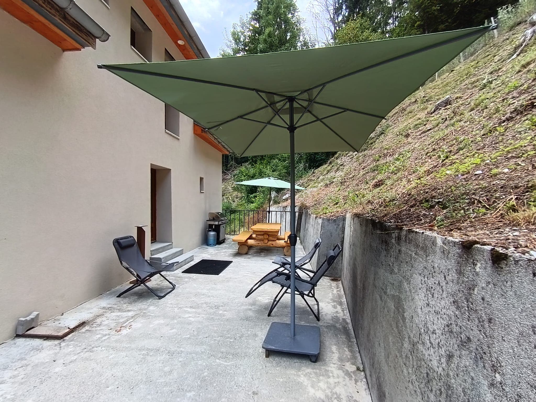 Terrasse de l'étage, clôturée par un portillon, avec barbecue